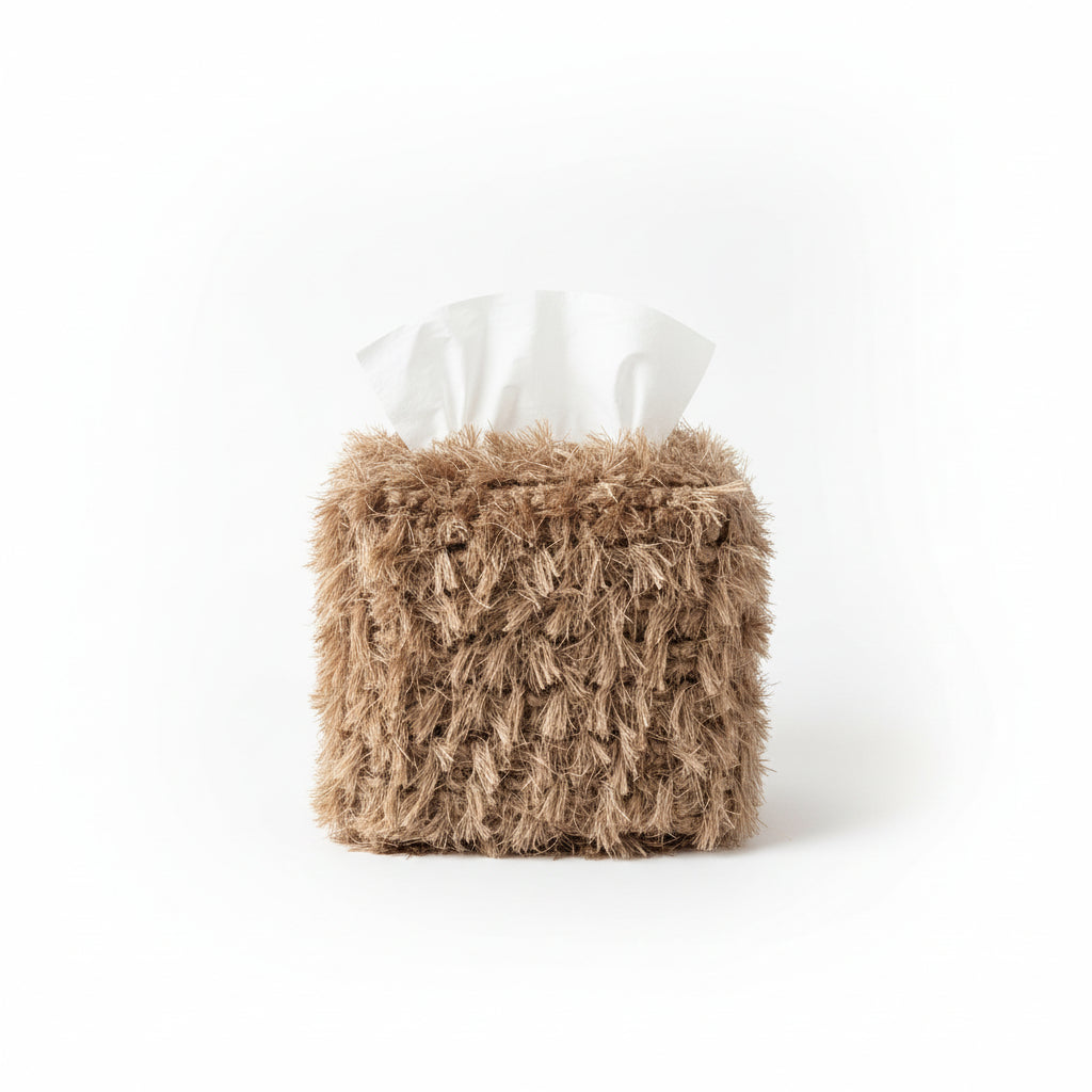 Close-up of a fluffy brown toy with a white bow in a glass display case.