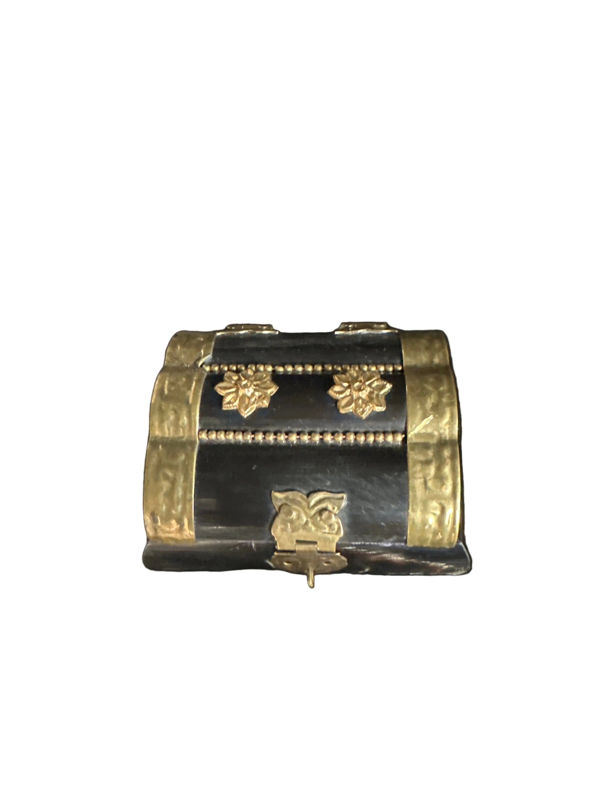 Decorative black and gold cylindrical object on a dark background