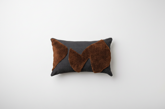 Abstract cushions by Saardé in black and chocolate with modern, artistic patterns, perfect for stylish home decor.