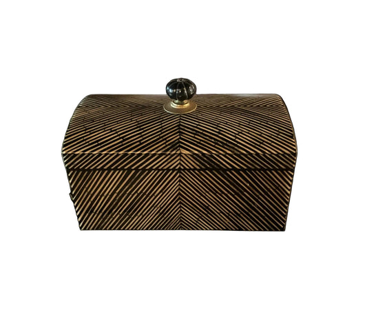 Decorative box with a striped pattern on a black background