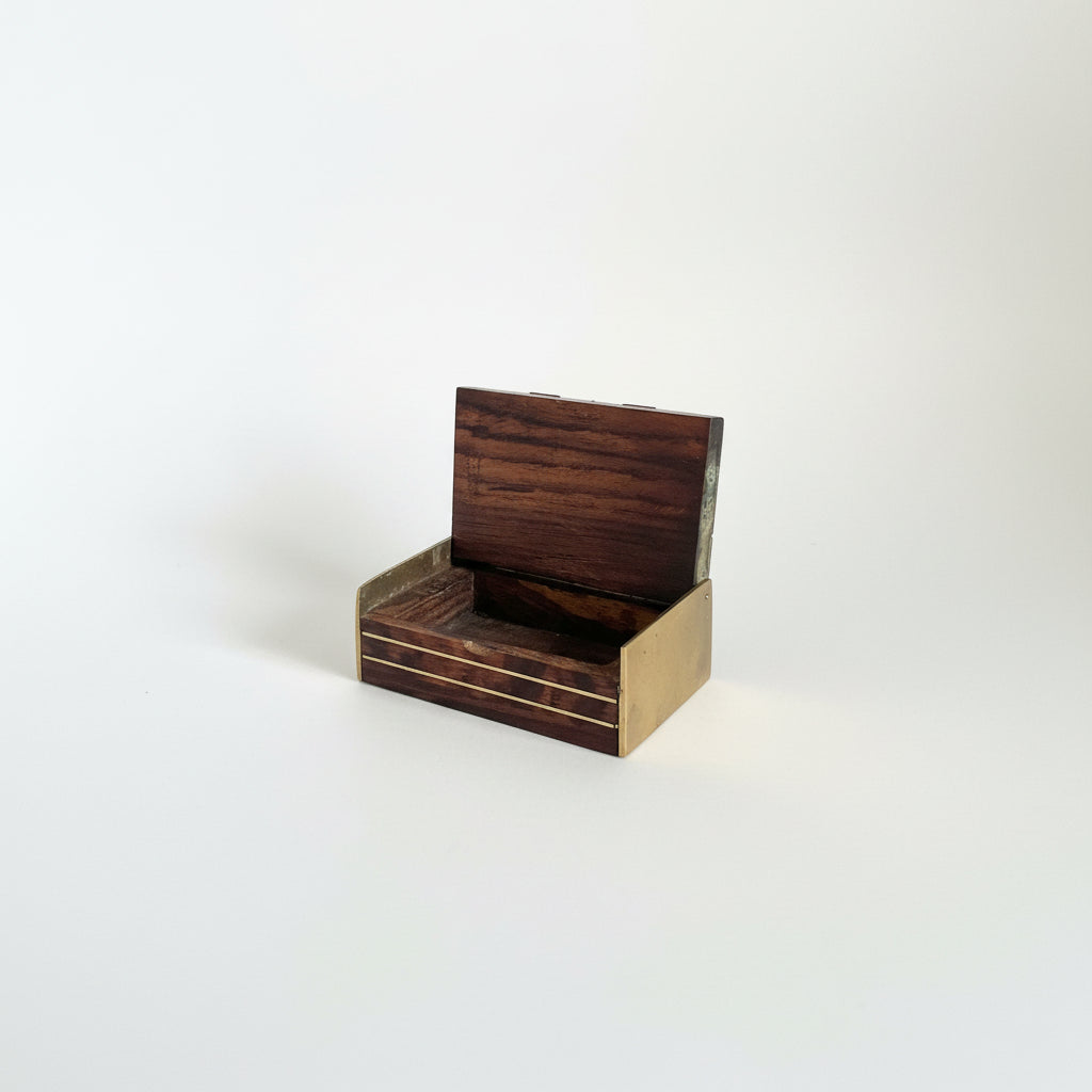 Small wooden model of a bench on a dark surface