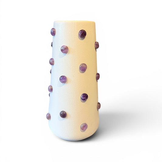 Amethyst stone vase by The Vault Creative with a polished, rounded shape and vibrant purple hue, showcasing natural stone patterns.
