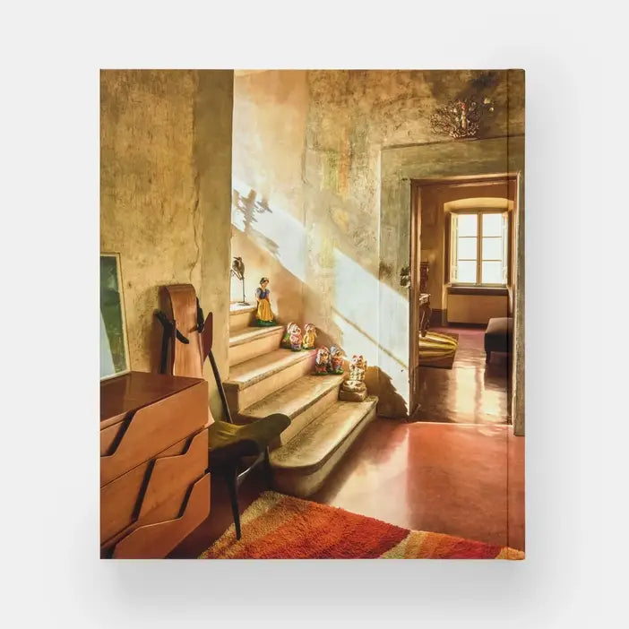 Cover image of Italian Interiors: Rooms With A View book by Phaidon, showcasing an elegant Italian interior with a scenic view through large windows.