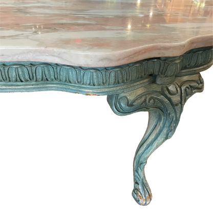 Pink marble coffee table by Ozmun Home with a sleek, modern design and smooth surface on a minimalistic living room floor.