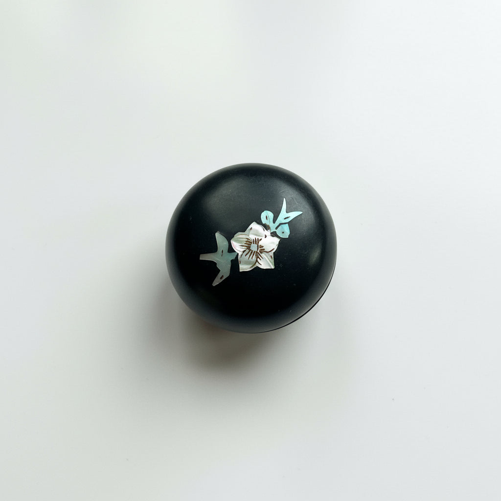 Black round box with floral design 