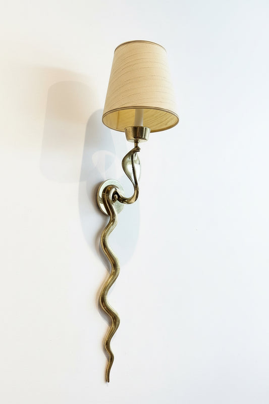 Vintage brass snake sconces with intricate detailing, designed for wall mounting, by The Vault Creative.