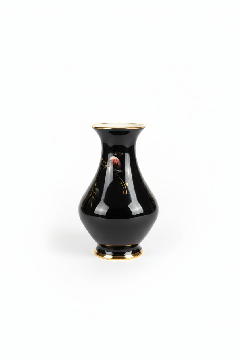 Black vase with gold rim and floral design on a white background