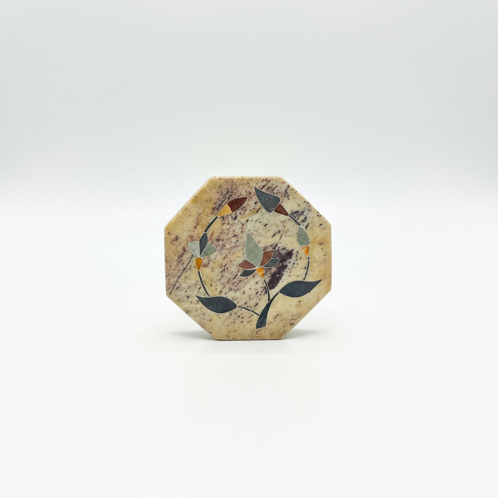 Decorative stone with floral design on a dark surface