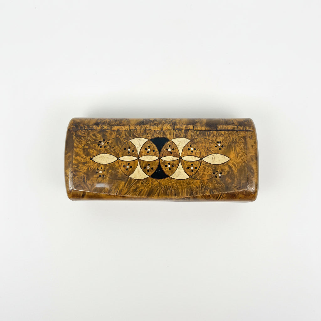Wooden box with gold inlay on a dark surface