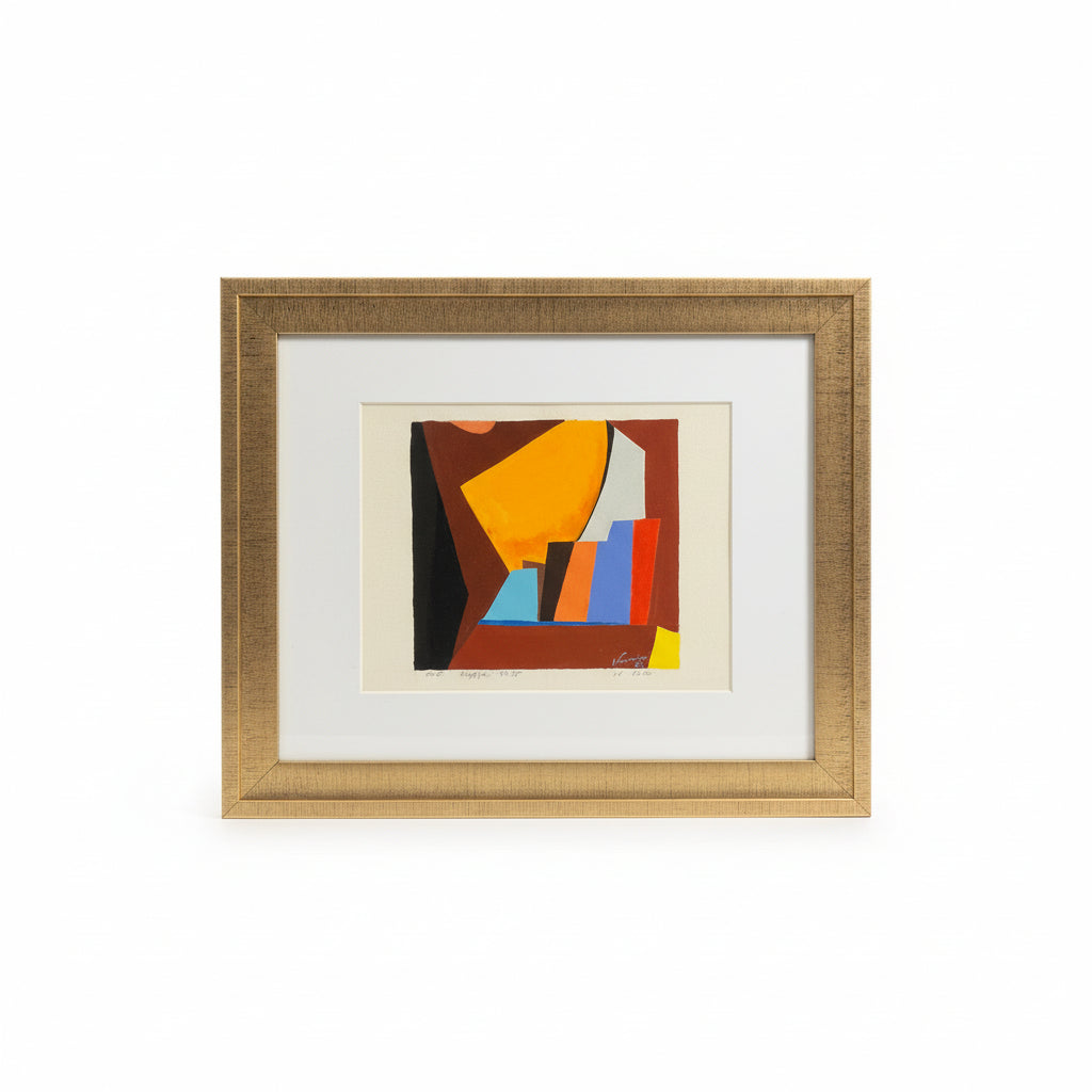 Framed abstract artwork with geometric shapes on a desk