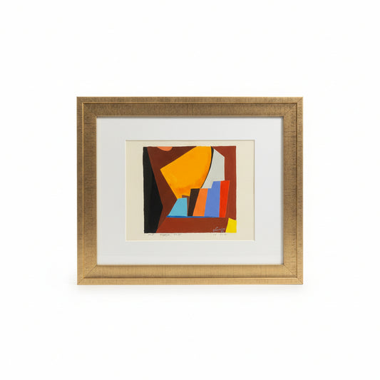 Framed abstract artwork with geometric shapes on a desk