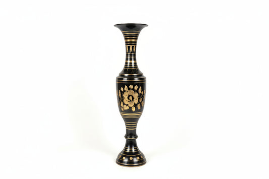 Decorative vase with black and gold design on a white surface