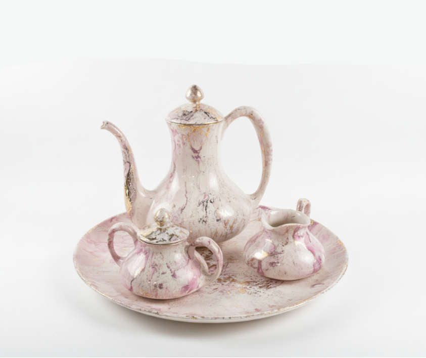 Vintage-style teapot set with distressed finish on a marble surface