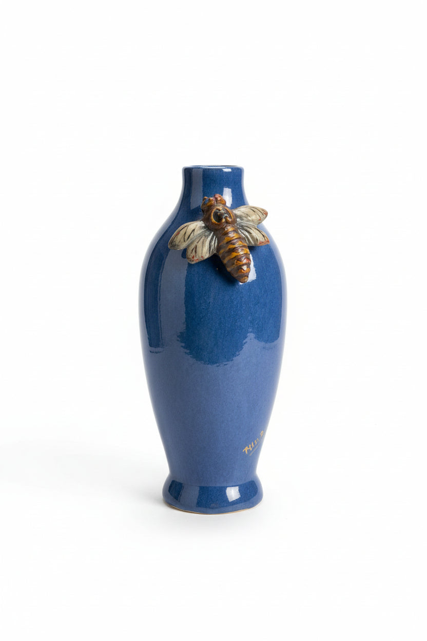 Blue ceramic bottle with bee as adecorative elements 