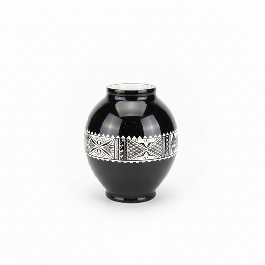 Black vase with silver geometric patterns on a white background