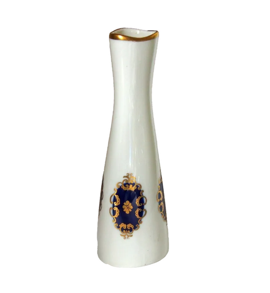 White vase with gold and blue decorative elements on a white background