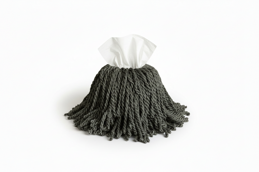 green mop tissue box with a white paper towel on a white background