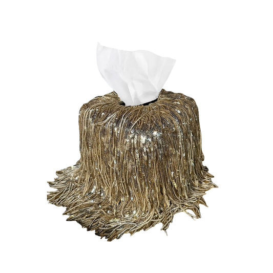 Gold sequin tissue box cover with white tissues on a white background